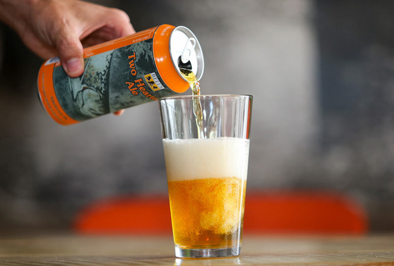 A photo of a man's hand pouring a refreshing looking Bell's Two Hearted Ale beer.